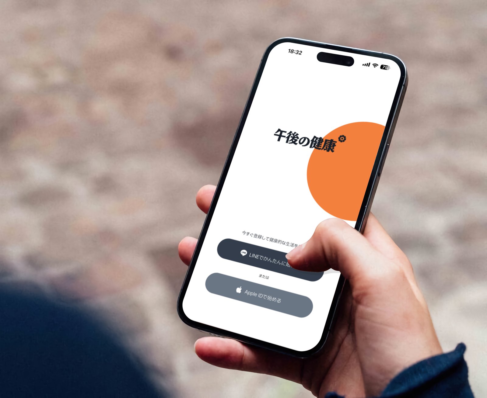 午後の健康アプリの起動画面を表示したスマートフォンを手にする様子